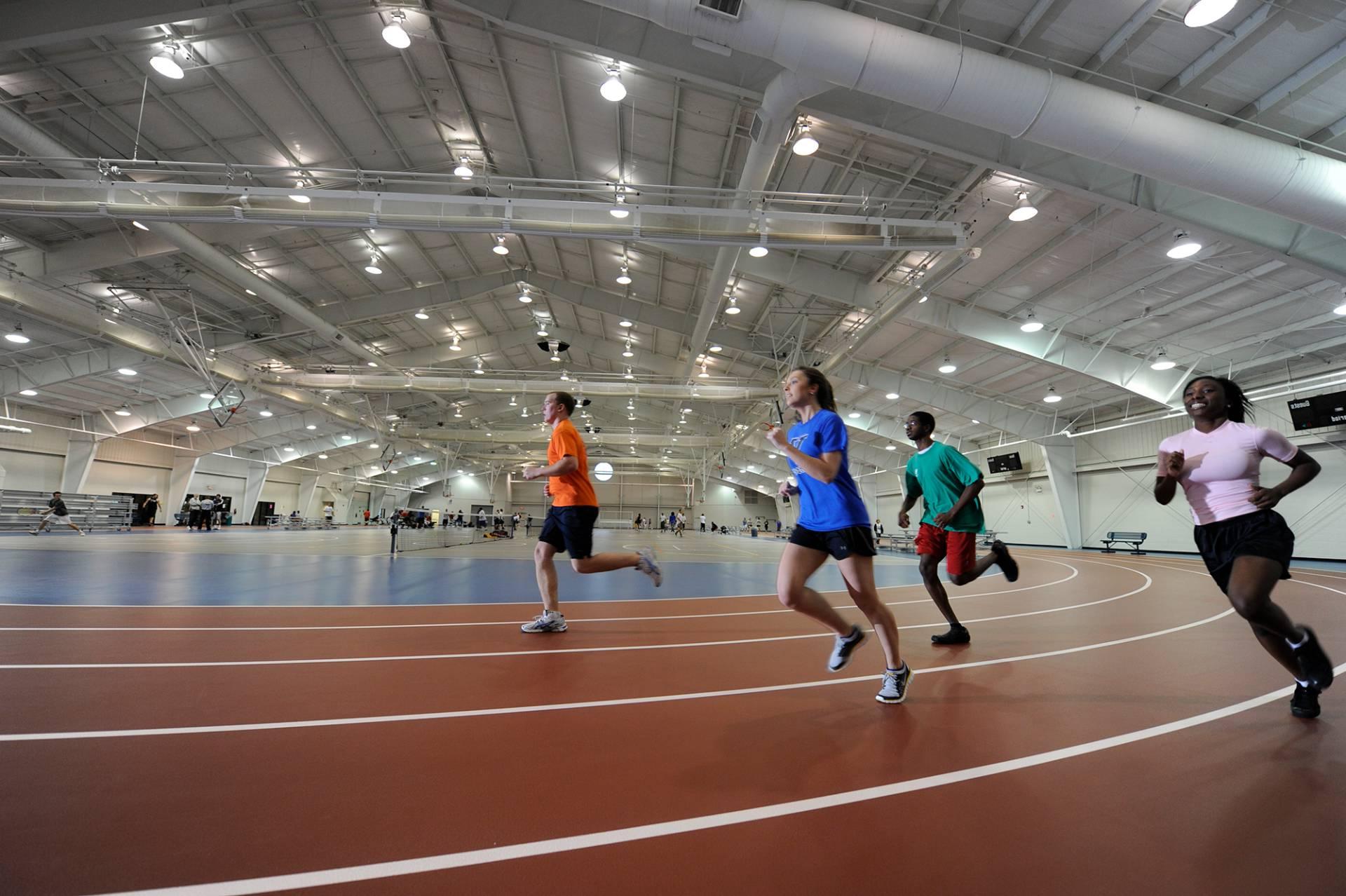 Students running around an indoor track.